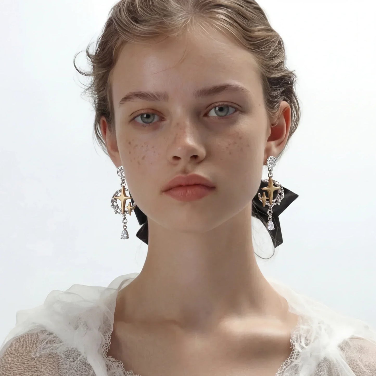 Celestial Star Drops mixed-metal earrings with hammered silver, brushed gold star, silver vines, and pear-cut zirconia dangle