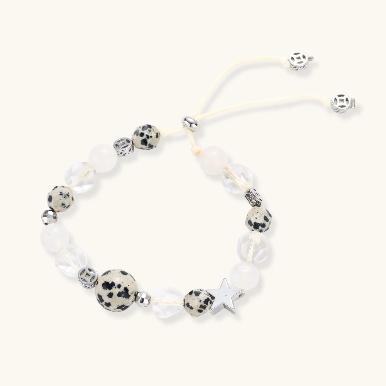 Cosmic Dalmatian Bracelet with dalmatian-spotted centerpiece, frosted quartz beads, silver star charm, and adjustable ivory cord