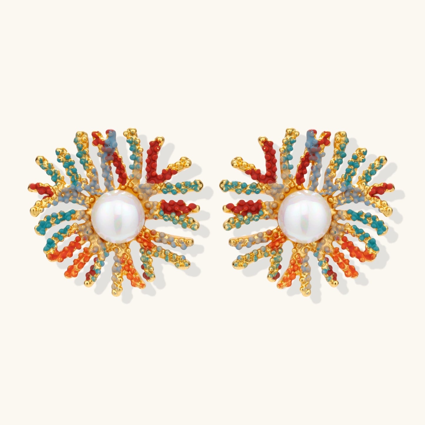 Vibrant starburst stud earrings with multicolor enamel rays and white pearl centers on gold-plated setting