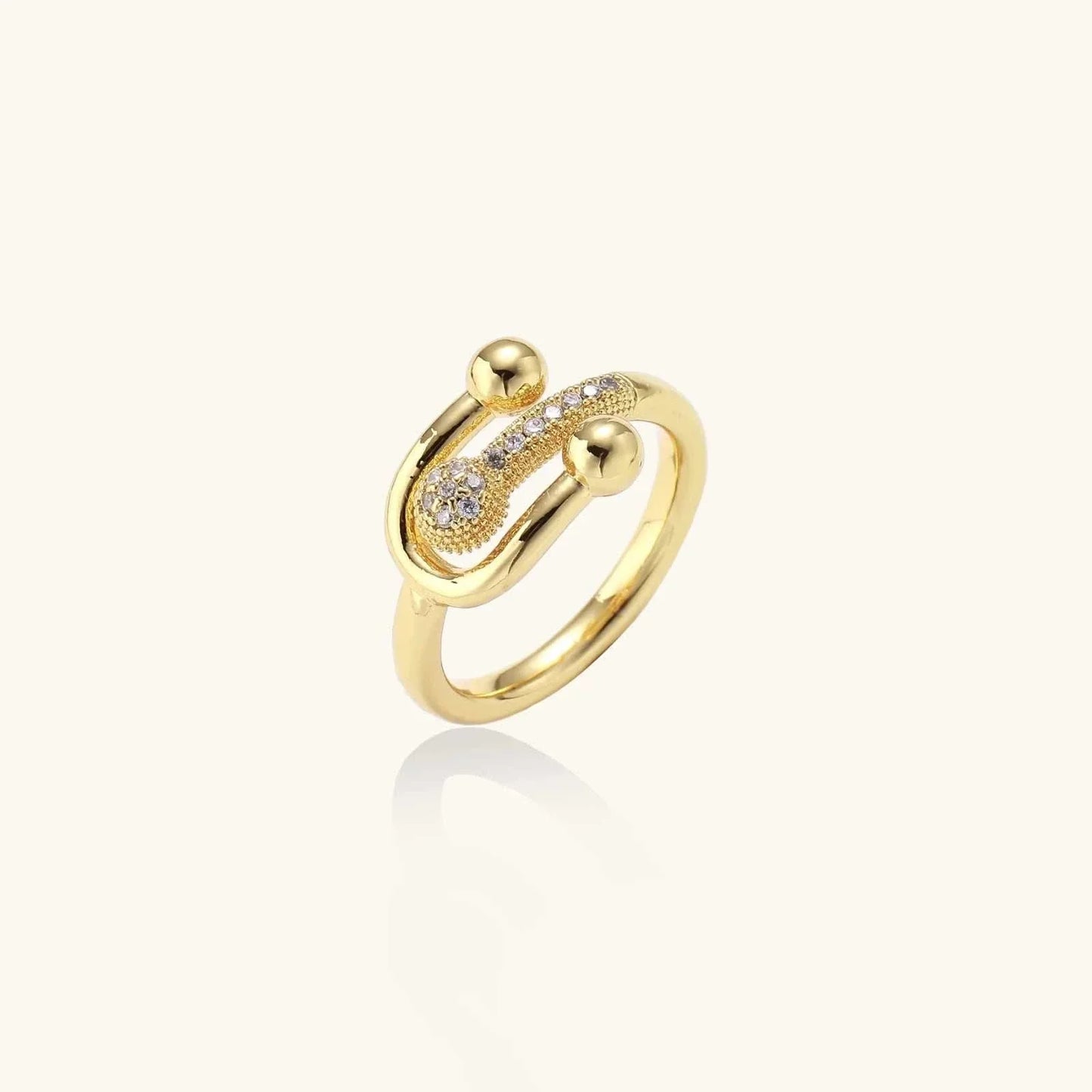 Close-up of adjustable Safety Pin Statement Ring in 18K gold plated eco-brass with pavé cubic zirconia and rounded gold beads